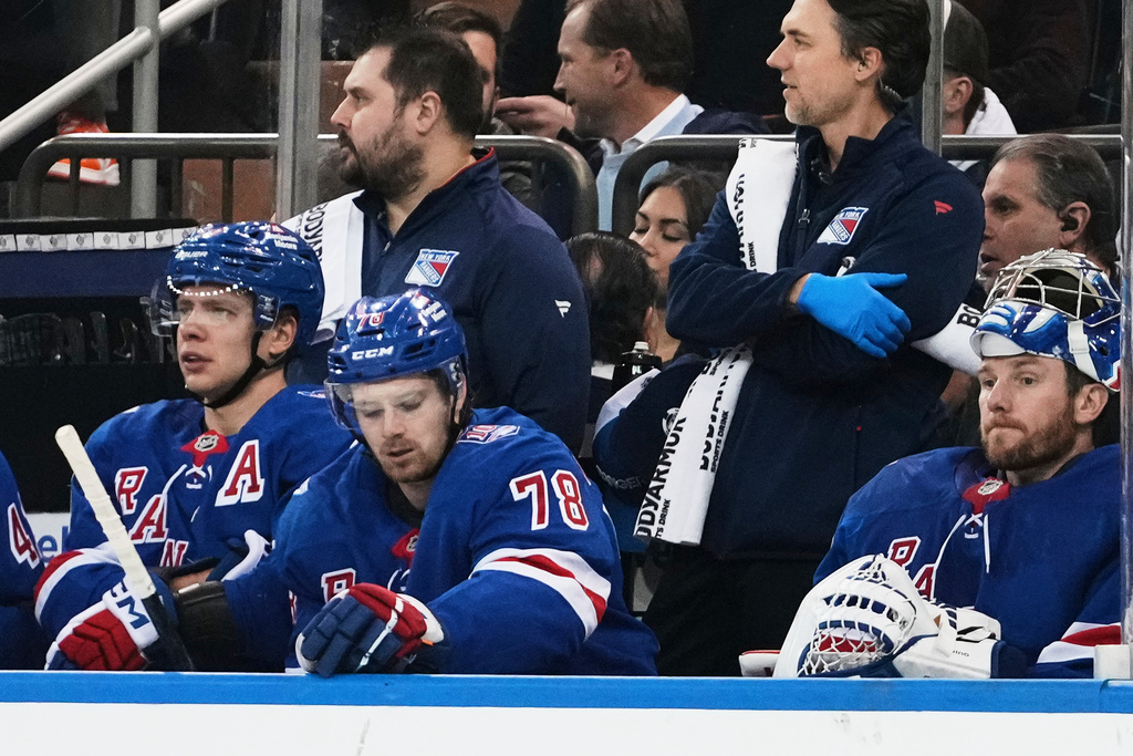 New York Rangers' Artemi Panarin, left, Brennan Othmann, center, and goaltender Jonathan Quick react during the second period of an NHL hockey game against the Ottawa Senators Wednesday, Jan. 14, 2026, in New York. (AP Photo/Frank Franklin II)