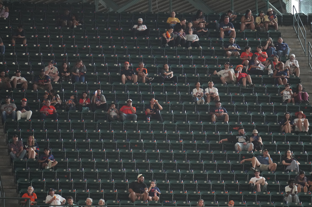 Fans sit among empty seats during the second inning in Game 1 of baseball's American League Wild Card Series between the Houston Astros and Chicago White Sox, Tuesday, Sept. 29, 2026, in Houston. (AP Photo/Karen Warren)