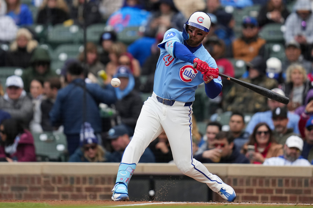 Chicago Cubs' Michael Busch (29) hits a two-run single during the first inning of a baseball game against the Arizona Diamondbacks, Friday, May 1, 2026, in Chicago. (AP Photo/Erin Hooley)