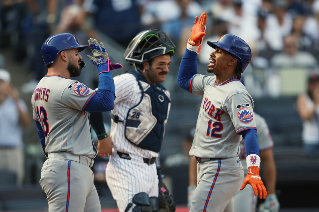 New York Mets' Francisco Lindor (12) high-fives Luis Torrens (13) after he hit a grand slam during the eighth inning of a baseball game against the New York Yankees, Saturday, Sept. 12, 2026, in New York. (AP Photo/Heather Khalifa)