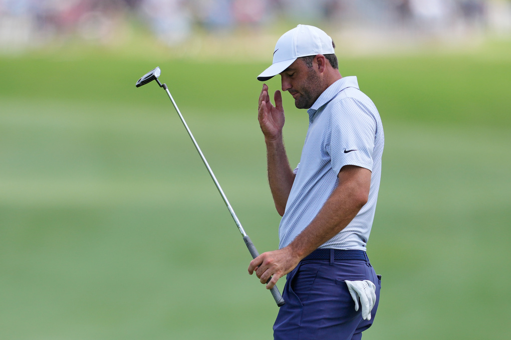 Scottie Scheffler reacts to leaving his putt short on the 10th green during the final round of the CJ Cup Byron Nelson golf tournament in McKinney, Texas, Sunday, May 24, 2026. (AP Photo/Tony Gutierrez)