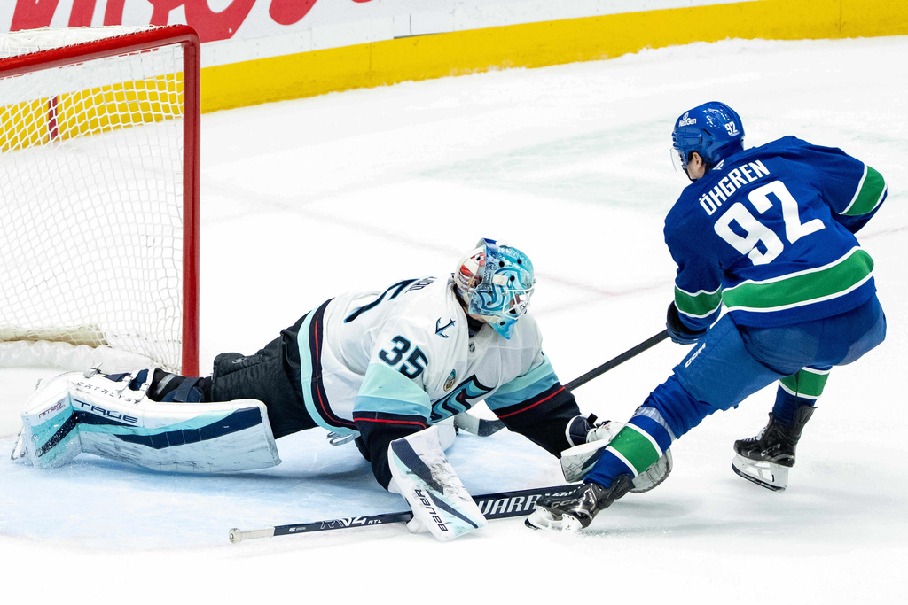 Seattle Kraken goaltender Joey Daccord (35) stops Vancouver Canucks' Liam Ohgren (92) in shootout NHL hockey action in Vancouver, Friday, Jan. 2, 2026. (Ethan Cairns/The Canadian Press via AP)