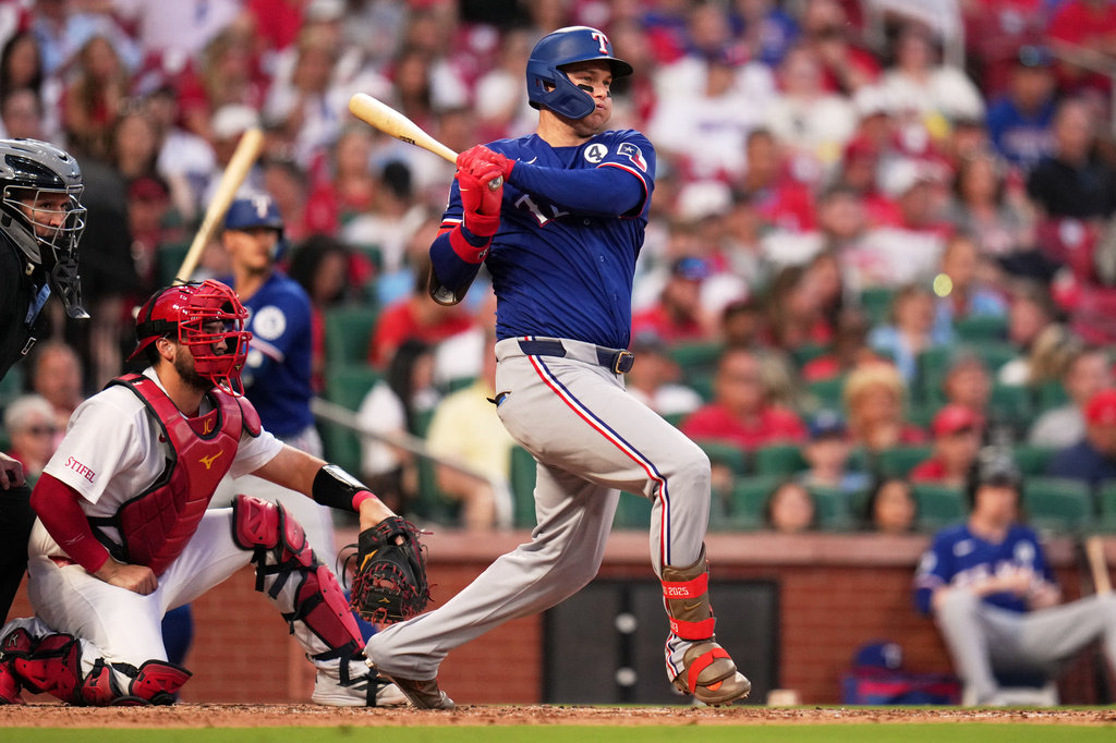 Texas Rangers' Joc Pederson follows through on an RBI double during the fifth inning of a baseball game against St. Louis Cardinals Tuesday, June 2, 2026, in St. Louis. (AP Photo/Jeff Roberson)