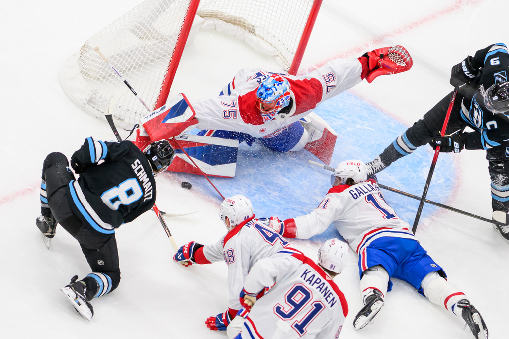 Montréal Canadiens goaltender Jakub Dobes (75) blocks the puck from the shot of Utah Mammoth center Nick Schmaltz (8) during the second period of an NHL hockey game, Wednesday, Nov. 26, 2025, in Salt Lake City. (AP Photo/Tyler Tate)