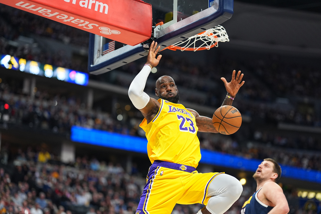 Los Angeles Lakers forward LeBron James dunks the ball for a basket to tie Kareem Abdul-Jabbar's record of 15,837 field goal in the first half of an NBA basketball game against the Denver Nuggets Thursday, March 5, 2026, in Denver. (AP Photo/David Zalubowski)