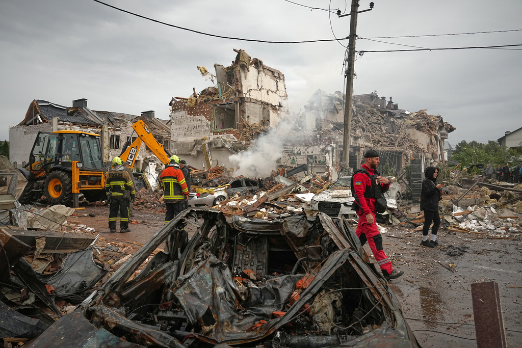 Rescuers work at the site of an apartment buildings damaged during a Russian attack in Kyiv, Ukraine, Sunday, Sept. 28, 2025. (AP Photo/Efrem Lukatsky)