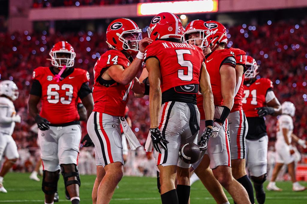 Georgia quarterback Gunner Stockton (14) celebrates with wide receiver Noah Thomas (5) after his touchdown during the first half of an NCAA college football game against Texas, Saturday, Nov. 15, 2025, in Athens, Ga. (AP Photo/Colin Hubbard)