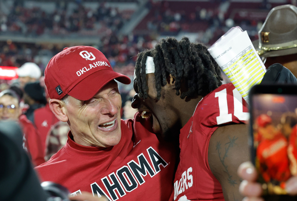 Oklahoma head coach Brent Venables celebrates with linebacker Kip Lewis (10) after defeating LSU during an NCAA college football game Saturday, Nov. 29, 2025, in Norman, Okla. (AP Photo/Alonzo Adams)