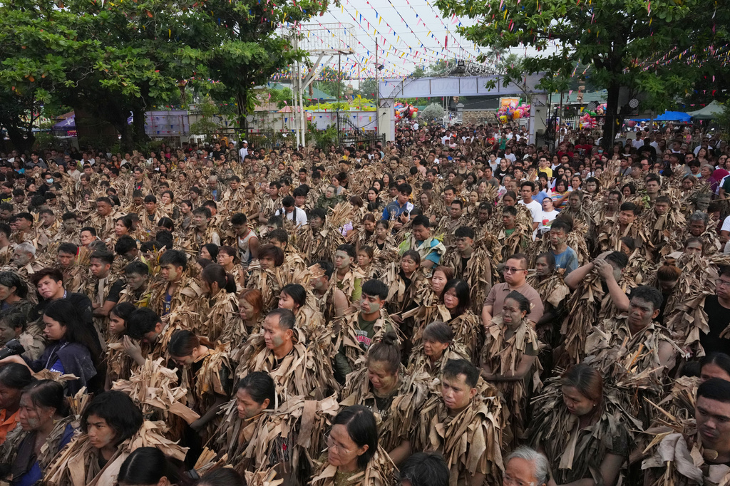 Catholic devotee covered in mud and dried banana leaves participate at the mud people festival on the feast day of Saint John the Baptist at Bibiclat, Nueva Ecija province, northern Philippines on Wednesday, June 24, 2026. (AP Photo/Aaron Favila)