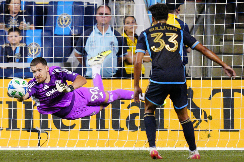 Toronto FC goalkeeper Luka Gavran (90) makes a diving save during the second half of an MLS soccer match against the Philadelphia Union, Saturday, Aug. 9, 2025, in Chester, Pa. (AP Photo/Derik Hamilton)