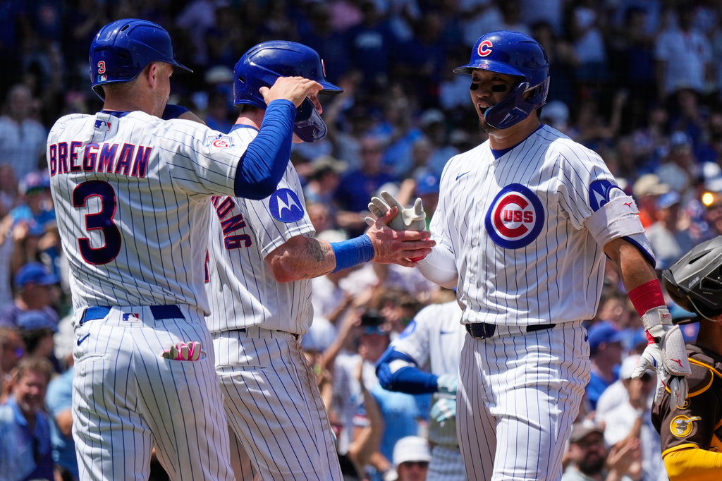 Chicago Cubs' Seiya Suzuki, right, of Japan, celebrates with Alex Bregman, left, and Pete Crow-Armstrong after hitting a three-run home run during the first inning of a baseball game against the San Diego Padres in Chicago, Wednesday, July 1, 2026. (AP Photo/Nam Y. Huh)