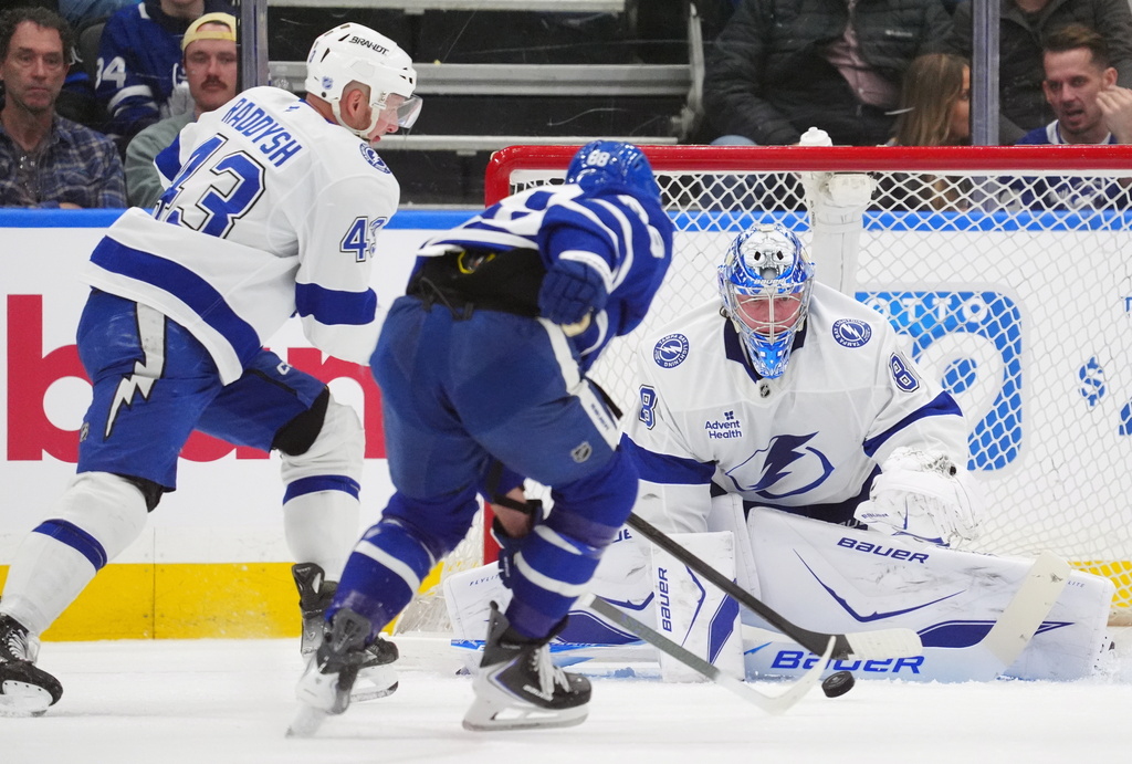 Toronto Maple Leafs William Nylander (88) is stopped by Tampa Bay Lightning goaltender Andrei Vasilevskiy (88) as Darren Raddysh (43) defends during first period NHL action in Toronto, on Saturday, March 7, 2026. (Frank Gunn/The Canadian Press via AP)