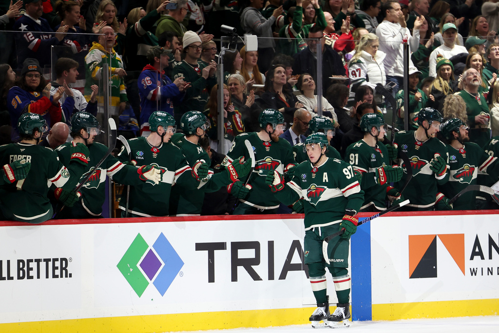 Minnesota Wild left wing Kirill Kaprizov (97) celebrates at the bench after scoring a goal during the second period of an NHL hockey game against the St. Louis Blues, Sunday, March 1, 2026, in St. Paul, Minn. (AP Photo/Ellen Schmidt)