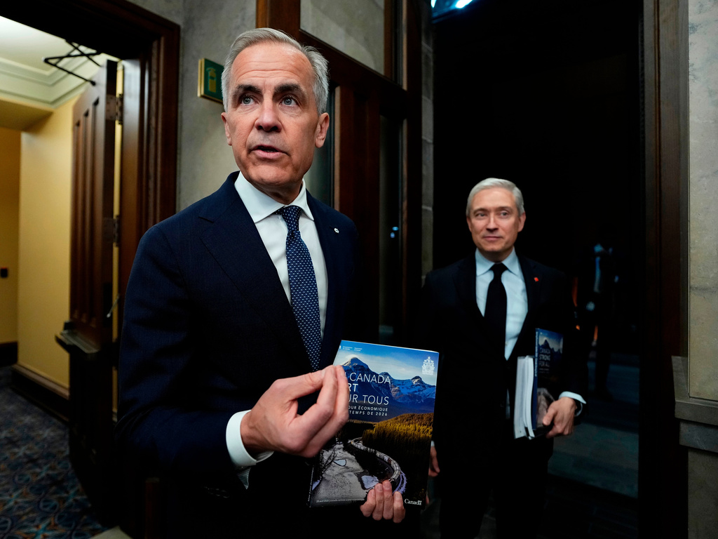Canada's Prime Minister Mark Carney, left, and Minister of Finance and National Revenue, Francois-Philippe Champagne, make their way to the House of Commons before the tabling of the spring economic update, on Parliament Hill, in Ottawa, Ontario, Tuesday, April 28, 2026. (Justin Tang/The Canadian Press via AP)