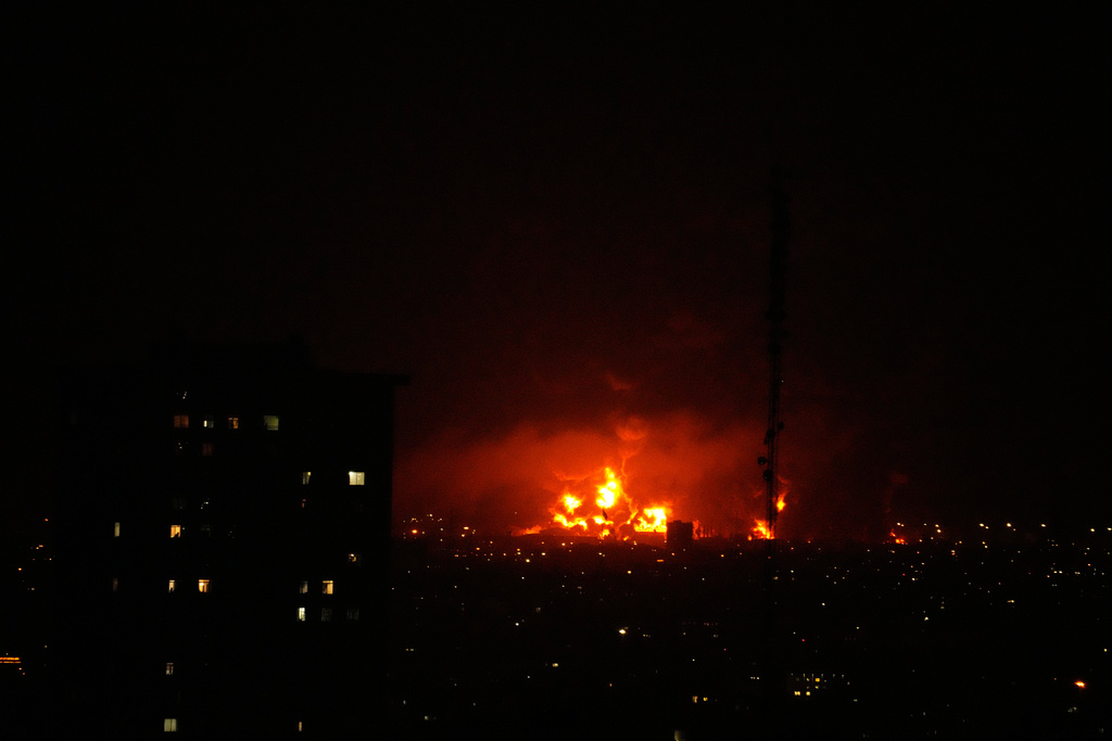 Flames rise from an oil storage facility south of the capital Tehran as strikes hit the city during the U.S.–Israeli military campaign, Iran, Saturday, March 7, 2026. (AP Photo/Vahid Salemi)
