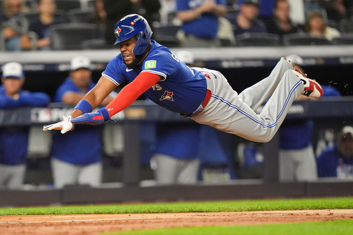 Toronto Blue Jays Vladimir Guerrero Jr. dives into home plate to score against the New York Yankees during the third inning of Game 3 of baseball's American League Division Series, Tuesday, Oct. 7, 2025, in New York. (AP Photo/Frank Franklin II) Toronto Blue Jays Vladimir Guerrero Jr. dives into home plate to score against the New York Yankees during the third inning of Game 3 of baseball's American League Division Series, Tuesday, Oct. 7, 2025, in New York. (AP Photo/Frank Franklin II)