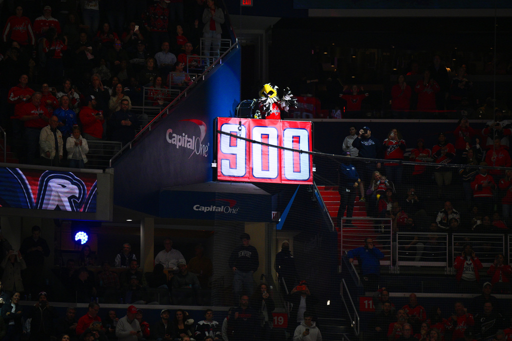Banner is unfurled after Washington Capitals left wing Alex Ovechkin (8) scored his 900th career NHL goal during the second period of an NHL hockey game against the St. Louis Blues, Wednesday, Nov. 5, 2025, in Washington. (AP Photo/Nick Wass)