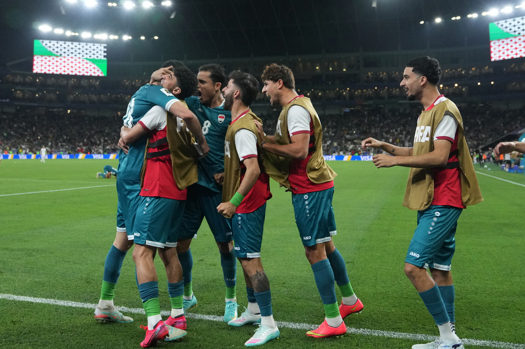 Iraq's Aymen Hussein, left, is congratulated after scoring his side's 2nd goal during the World Cup playoff final soccer match between Iraq and Bolivia in Monterrey, Mexico, Tuesday, March 31, 2026. (AP Photo/Fernando Llano)