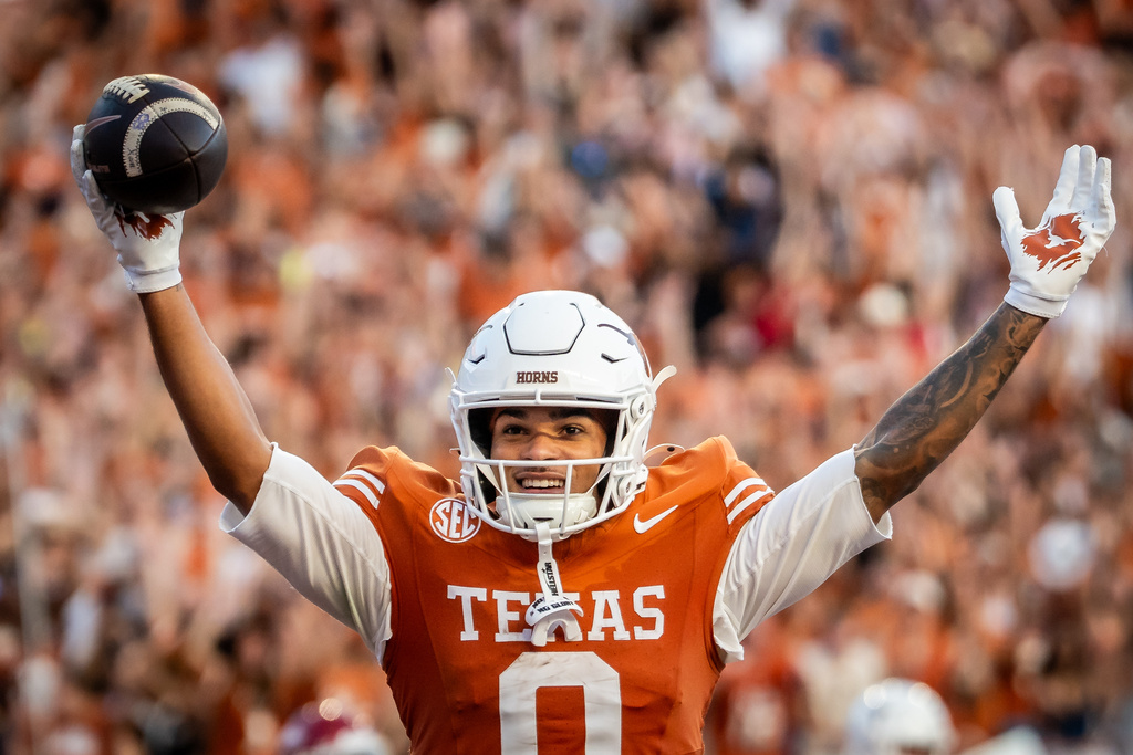 Texas Longhorns wide receiver Deandre Moore Jr. (0) celebrates a touchdown in the third quarter of an NCAA college football game against Arkansas Saturday, Nov. 22, 2025, in Austin, Texas.(Sara Diggins/Austin American-Statesman via AP)