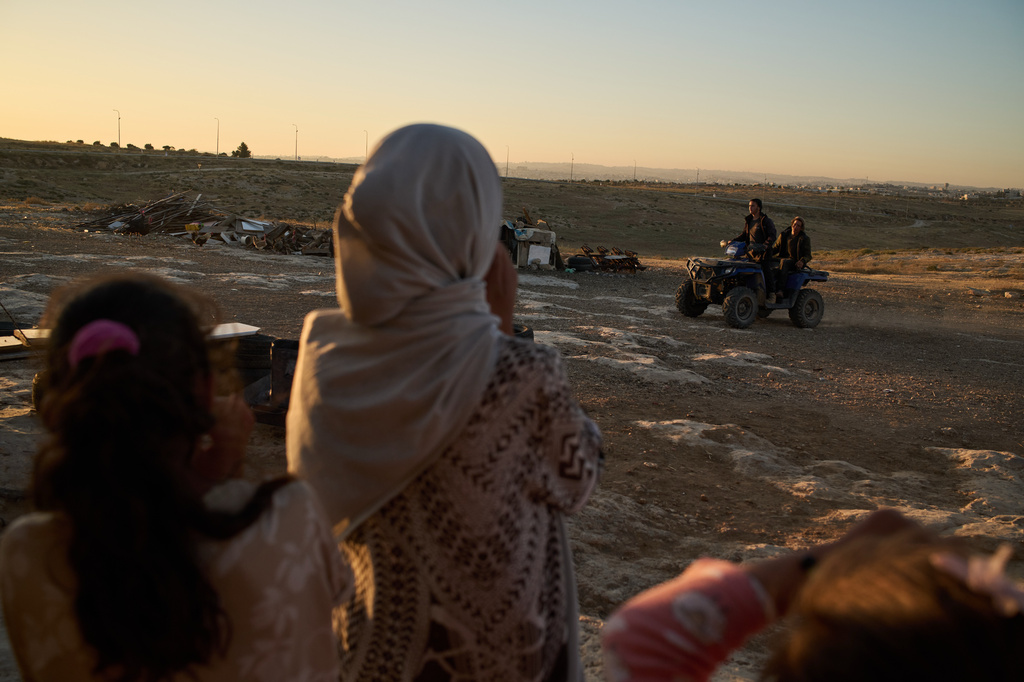 Palestinian girls watch Israeli settlers riding a quad bike past their community near the West Bank village of Susya, in the Masafer Yatta region, Wednesday, June 17, 2026.(AP Photo/Leo Correa)