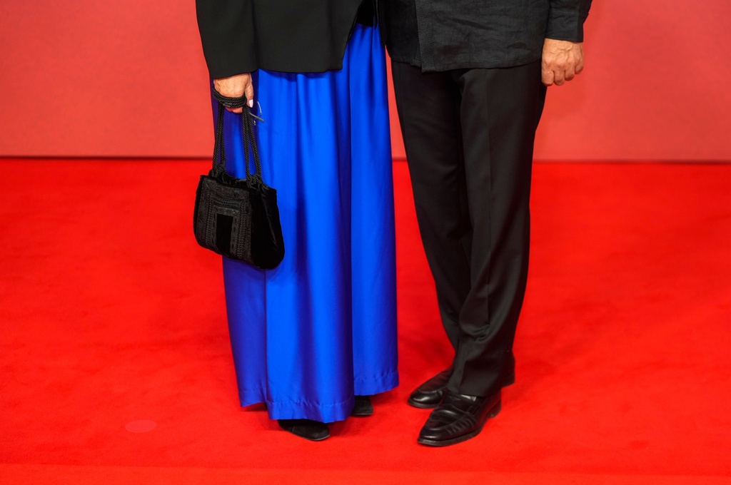 A couple poses for a photo on the red carpet during the opening ceremony of the 22nd Marrakech Film Festival, in Morocco, Friday, Nov. 28, 2025. (AP Photo/Mosa'ab Elshamy)