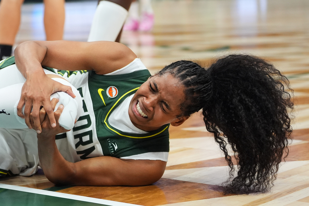 Seattle Storm guard Zia Cooke holds her knee after going down during the first half of a WNBA basketball game against the Las Vegas Aces, Thursday, Sept. 17, 2026, in Seattle. (AP Photo/Lindsey Wasson)