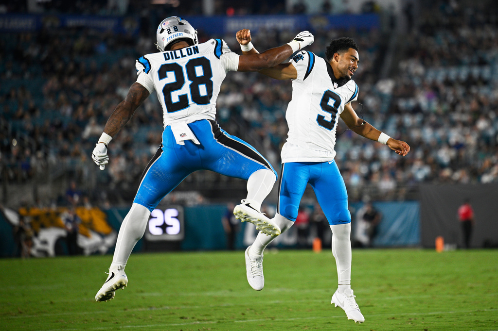 Carolina Panthers running back AJ Dillon celebrates after scoring with quarterback Bryce Young during the first half of an NFL preseason football game against the Jacksonville Jaguars, Friday, Aug. 21, 2026, in Jacksonville, Fla. (AP Photo/Phelan M. Ebenhack)