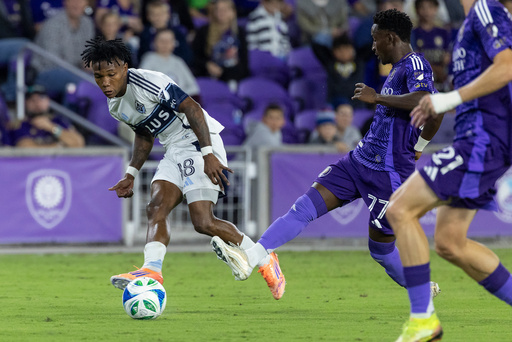 Orlando City forward Iván Angulo (77) defends goal shot from Vancouver Whitecaps defender Édier Ocampo (18) during the first half of an MLS soccer match, Saturday, Oct. 11, 2025, in Orlando, Fla. (AP Photo/Kevin Kolczynski) Orlando City forward Iván Angulo (77) defends goal shot from Vancouver Whitecaps defender Édier Ocampo (18) during the first half of an MLS soccer match, Saturday, Oct. 11, 2025, in Orlando, Fla. (AP Photo/Kevin Kolczynski)