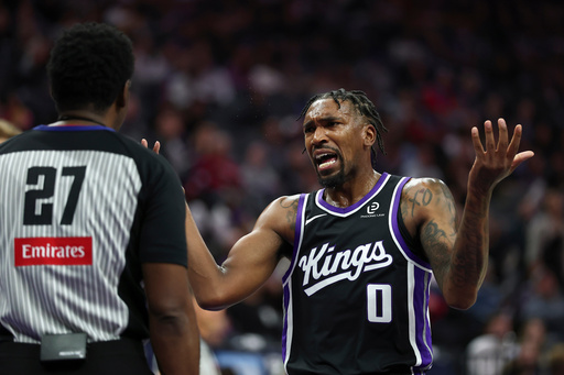 Sacramento Kings guard Malik Monk (0) disputes a call with referee Mitchell Ervin (27) during the first half of an NBA basketball game against the Los Angeles Lakers, Sunday, Oct. 26, 2025, in Sacramento, Calif. (AP Photo/Sara Nevis) Sacramento Kings guard Malik Monk (0) disputes a call with referee Mitchell Ervin (27) during the first half of an NBA basketball game against the Los Angeles Lakers, Sunday, Oct. 26, 2025, in Sacramento, Calif. (AP Photo/Sara Nevis)