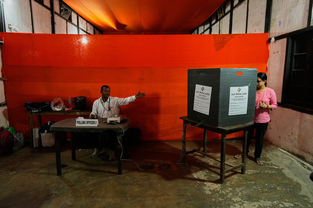 A woman casts her vote at a polling center during the state election in Guwahati, India, Thursday, April 9, 2026. (AP Photo/Anupam Nath)