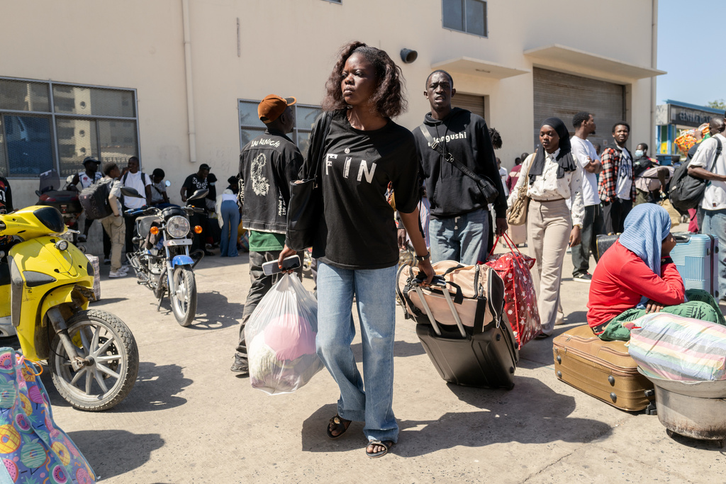 Students carry their belongings as they leave the Cheikh Anta Diop University, which is being evacuated following the death of second year student Abdoulaye Ba, in Dakar Tuesday, Feb. 10, 2026. (AP Photo/Sylvain Cherkaoui)