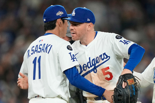 Los Angeles Dodgers relief pitcher Roki Sasaki, left, celebrates with first baseman Freddie Freeman (5) after a win over the Cincinnati Reds in Game 2 of the National League Wild Card baseball playoff series Wednesday, Oct. 1, 2025, in Los Angeles. (AP Photo/Mark J. Terrill) Los Angeles Dodgers relief pitcher Roki Sasaki, left, celebrates with first baseman Freddie Freeman (5) after a win over the Cincinnati Reds in Game 2 of the National League Wild Card baseball playoff series Wednesday, Oct. 1, 2025, in Los Angeles. (AP Photo/Mark J. Terrill)