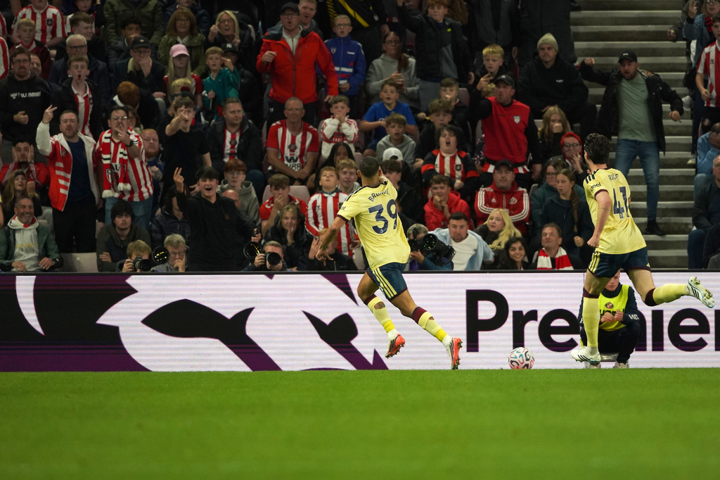 Arsenal's Bruno Guimaraes, center, celebrates after scoring the opening goal during the English Premier League soccer match between Sunderland and Arsenal in Sunderland, England, Saturday, Sept. 12, 2026. (AP Photo/Ian Hodgson)