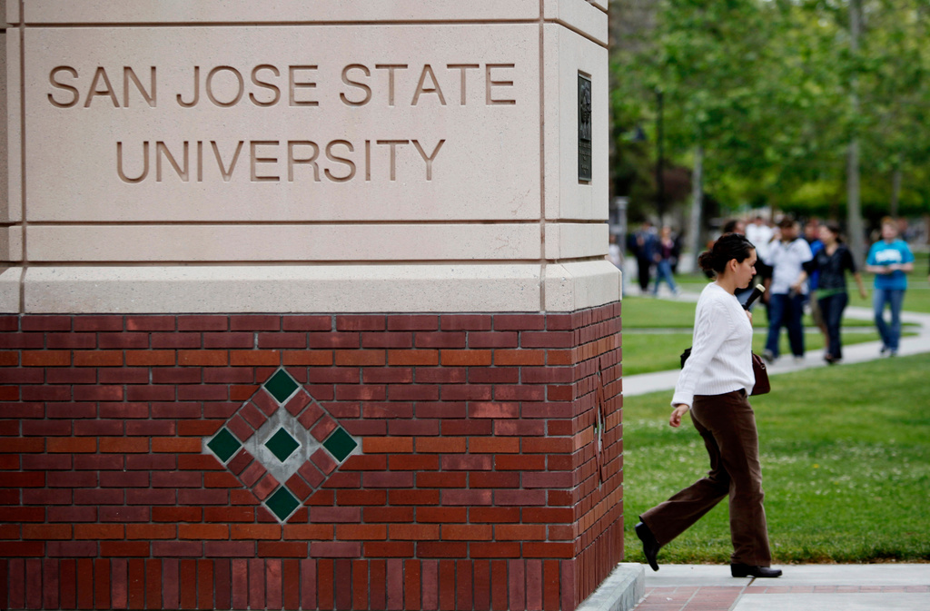 FILE - People walk on the campus of San Jose State University in San Jose, Calif., on May 5, 2009. (AP Photo/Paul Sakuma, File)