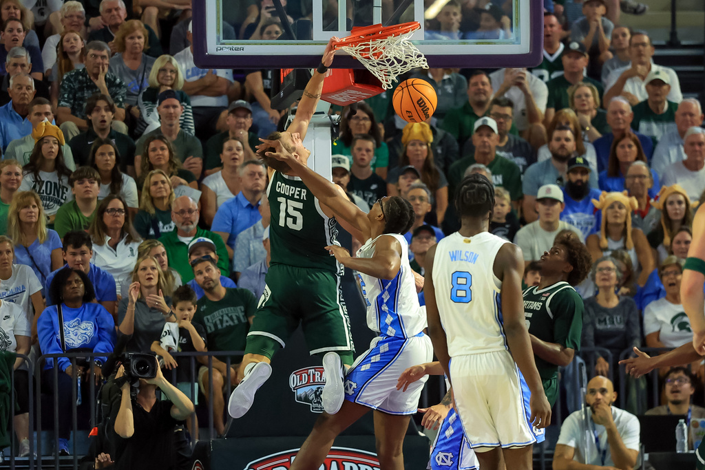 Michigan State center Carson Cooper (15) dunks against North Carolina forward James Brown, second from left, during the first half of an NCAA college basketball game Thursday, Nov. 27, 2025, in Fort Myers, Fla. (AP Photo/Mike Carlson)