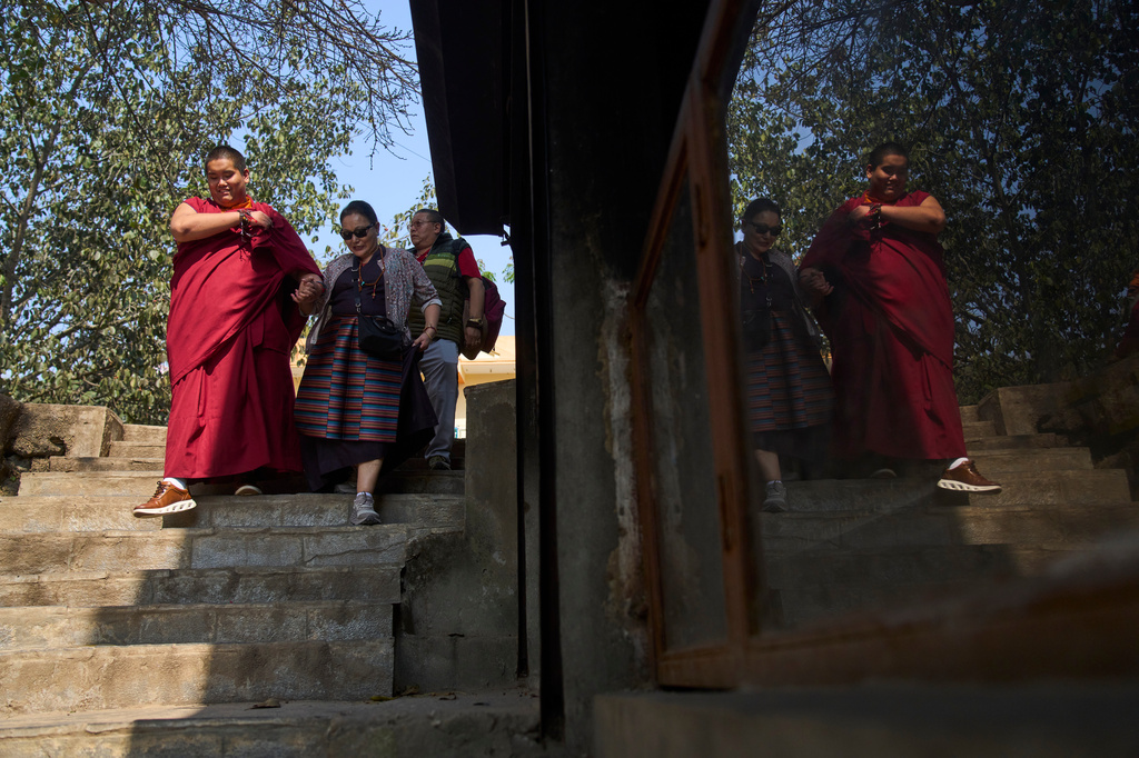 Jalue Dorje, left; his mother, Dechen Wangmo, center, and his father, Dorje Tsegyal walk towards the Halesi-Maratika Caves, 135 miles east of Kathmandu, Nepal, Monday, April 13, 2026. (AP Photo/Niranjan Shrestha)