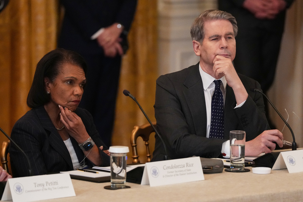 Former U.S. Secretary of State Condoleezza Rice and Treasury Secretary Scott Bessent attend a roundtable discussion on college sports in the East Room of the White House, Friday, March 6, 2026, in Washington. (AP Photo/Julia Demaree Nikhinson)