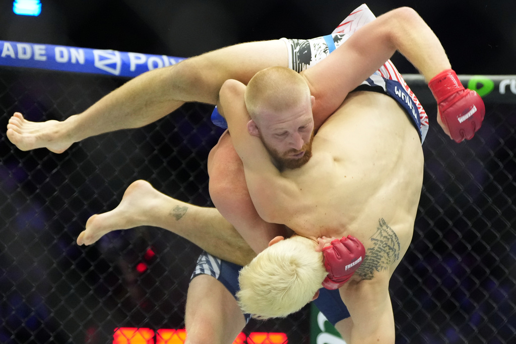 Bo Nickal, top, fights against Kyle Daukaus during their middleweight bout at UFC Freedom 250 on the South Lawn of the White House, Sunday, June 14, 2026, in Washington. (AP Photo/Alex Brandon)