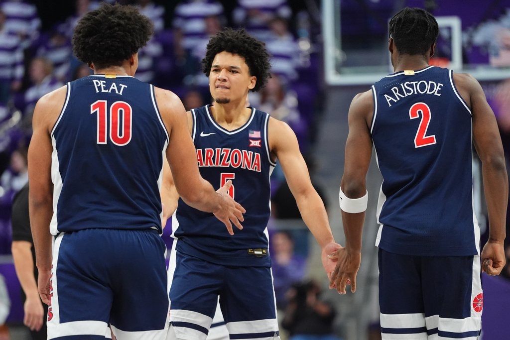 Arizona guard Brayden Burries (5) celebrates a play with teammates forward Koa Peat (10) and guard Dwayne Aristode (2) during the first half of an NCAA college basketball game against TCU Saturday, Jan. 10, 2026, in Fort Worth, Texas. (AP Photo/LM Otero)