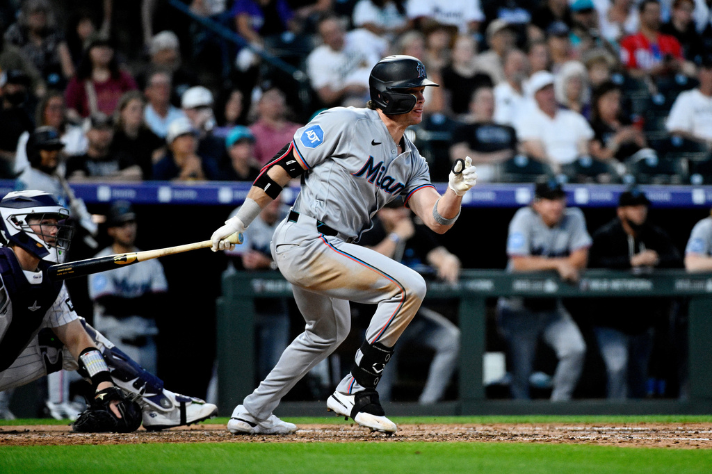 Miami Marlins' Griffin Conine begins to run to first base on an RBI-single in the sixth inning of a baseball game against the Colorado Rockies Tuesday, June 30, 2026, in Denver. (AP Photo/Geneva Heffernan)
