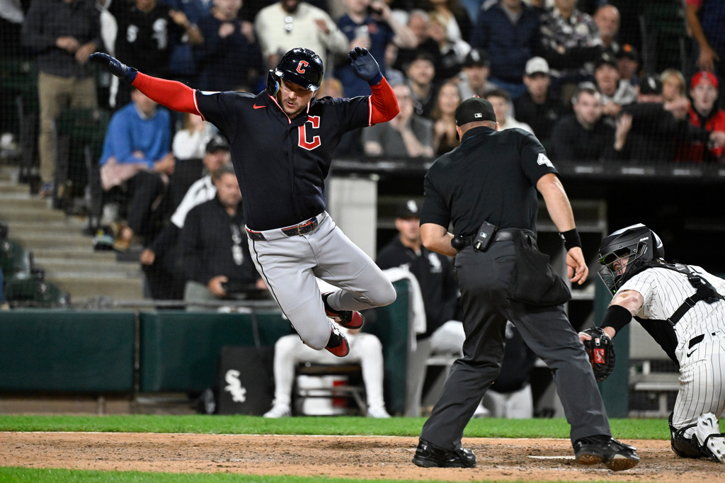 Cleveland Guardians' Patrick Bailey, left, scores past Chicago White Sox catcher Kyle Teel, right, during the ninth inning of a baseball game, Monday, June 22, 2026, in Chicago. (AP Photo/Matt Marton)