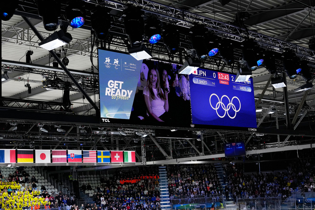 Fans are seen on a screen during an intermission of a preliminary round match of women's ice hockey between Japan and Sweden at the 2026 Winter Olympics, in Milan, Italy, Tuesday, Feb. 10, 2026. (AP Photo/Petr David Josek)