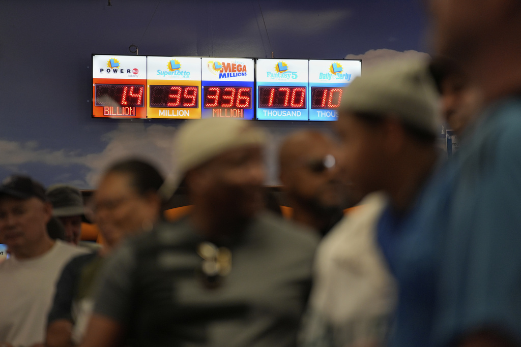 People wait in line to buy lottery tickets at the Lotto Store just inside the California border Wednesday, Sept. 3, 2025, near Primm, Nev. (AP Photo/John Locher)