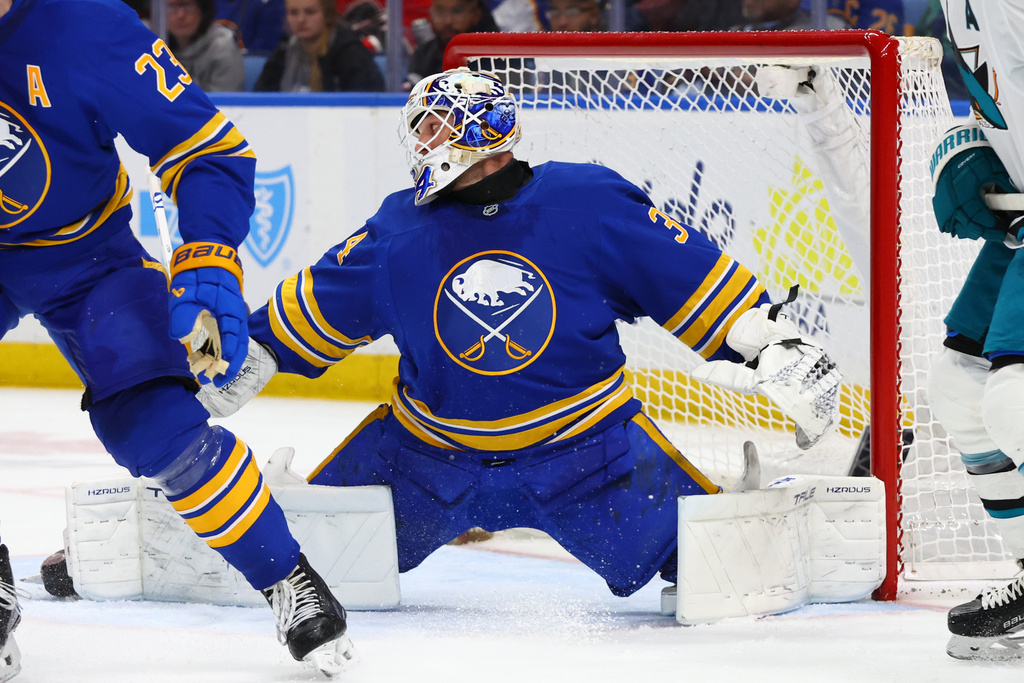 Buffalo Sabres goaltender Alex Lyon (34) slides across the crease to make a save during the second period of an NHL hockey game against the San Jose Sharks Tuesday, March 10, 2026, in Buffalo, N.Y. (AP Photo/Jeffrey T. Barnes)