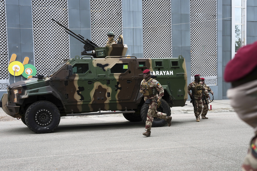 Guinean soldiers secure the area outside a polling station before Gen. Mamadi Doumbouya arrives to cast his vote in the constitutional referendum, in Conakry, Guinea, Sunday, Sept. 21, 2025. (AP Photo/Misper Apawu)