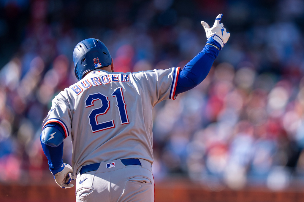 Texas Rangers' Jake Burger reacts to his two-run home run during the third inning of a baseball game against the Philadelphia Phillies, Saturday, March 28, 2026, in Philadelphia. (AP Photo/Chris Szagola)