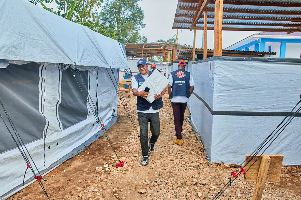 Health workers walk at the Evangelical Medical Center, in Bunia, eastern Congo, Friday, July 3, 2026, where Ebola clinical trials are scheduled to take place. (AP Photo/Dirole Lotsima Dieudonne)