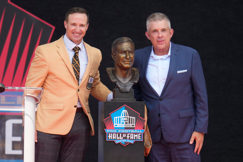 Former NFL player Drew Brees, left, unveils his bust with Sean Payton during the Pro Football Hall of Fame induction ceremony at the Pro Football Hall of Fame, in Canton, Ohio, Saturday, Aug. 8, 2026. (AP Photo/Sue Ogrocki)