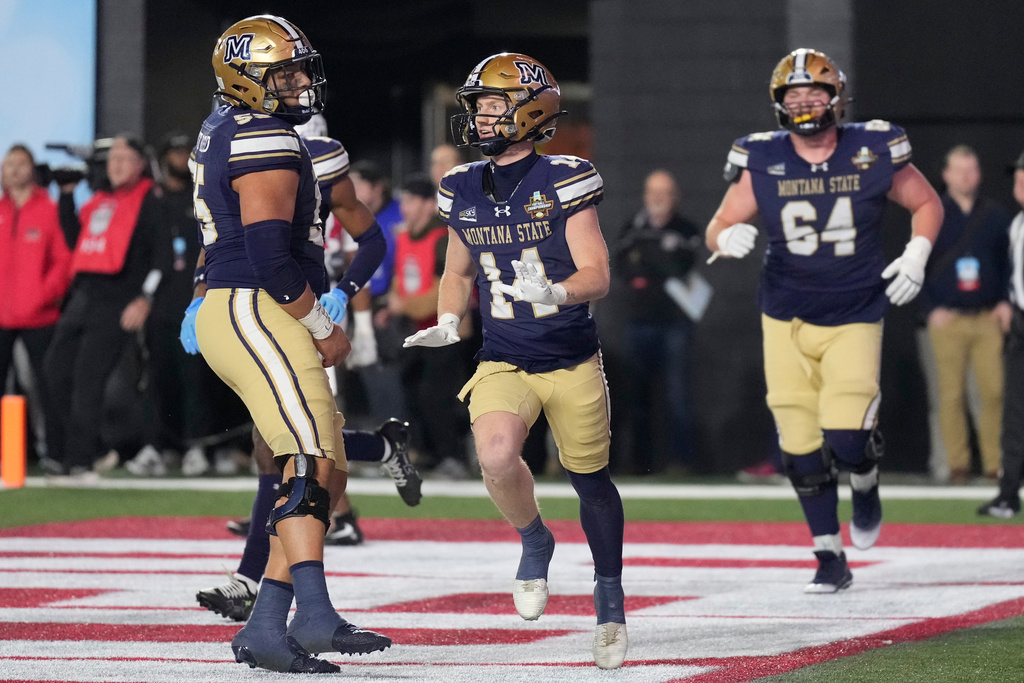 Montana State wide receiver Taco Dowler (14) celebrates his touchdown with teammates during overtime of the FCS Championship NCAA college football game Monday, Jan. 5, 2026, in Nashville, Tenn. (AP Photo/George Walker IV)