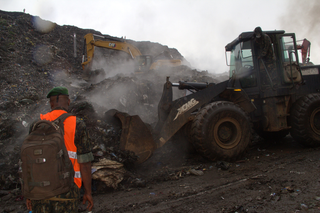 Rescue workers search through a heap of refuse after it collapsed at Conakry’s largest landfill, Guinea, Sunday, Aug. 23, 2026. (AP Photo/Fodo Toure)